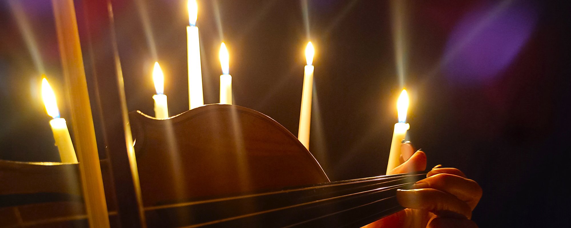Close up of violin playing by candlelight