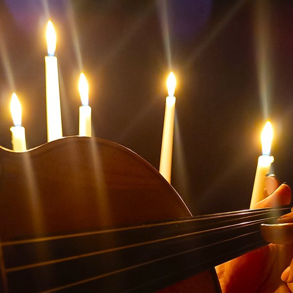 Close up of violin playing by candlelight