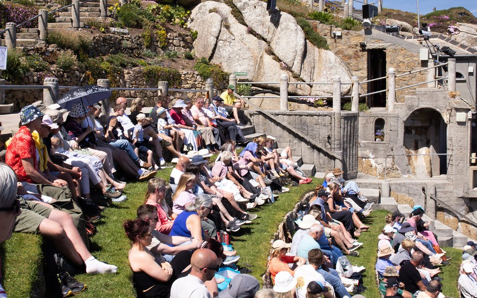 Audience watching a performance at the Minack on a sunny afternoon