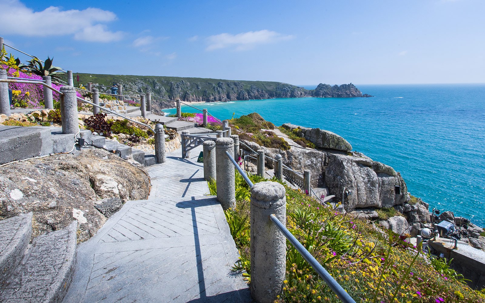 View of Porthcurno bay from the upper levels of the Minack with Logan Rock in background