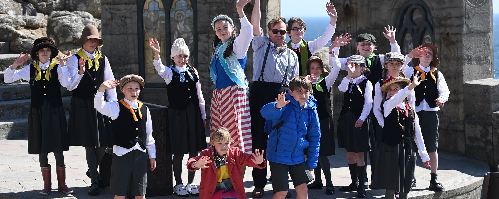 Young actors performing on the Minack stage