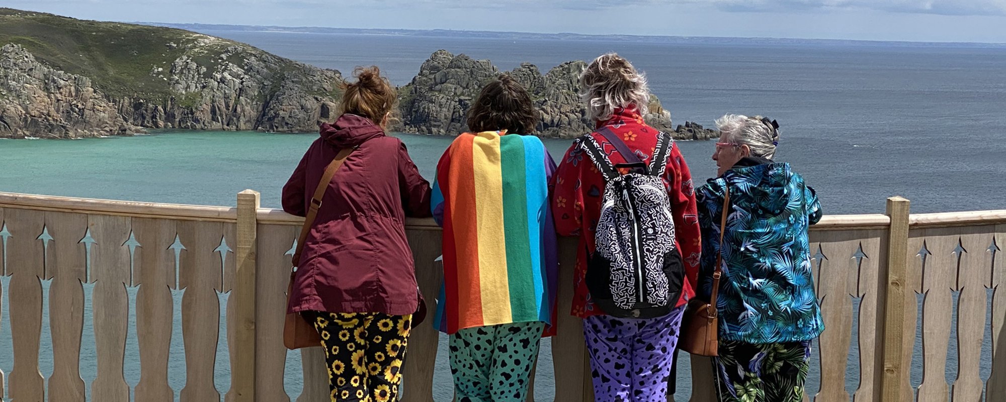 4 tourists enjoying the panorama from the Minack's viewing platform